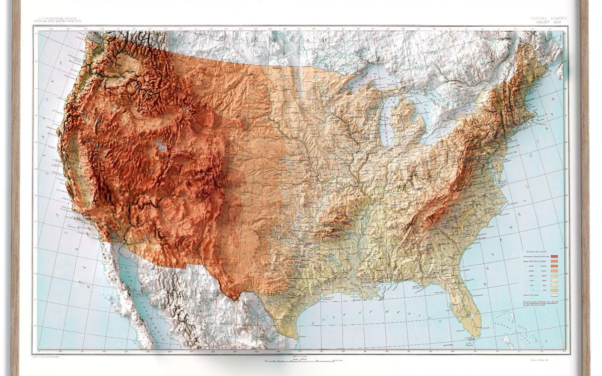 Shaded relief map with green lowlands grading through tan to brown peaks, illustrating the physical map definition